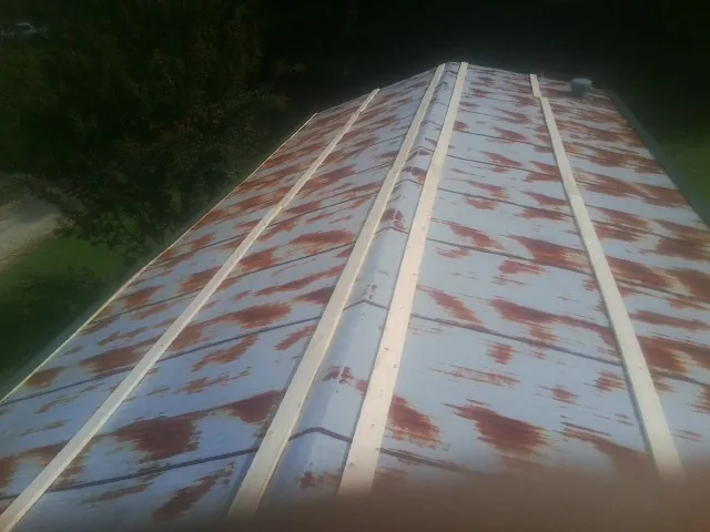 Rusted metal roof panels with new wood purlins before replacement — Storm Damage Roof Repair in Grassflat by Roofing Brothers