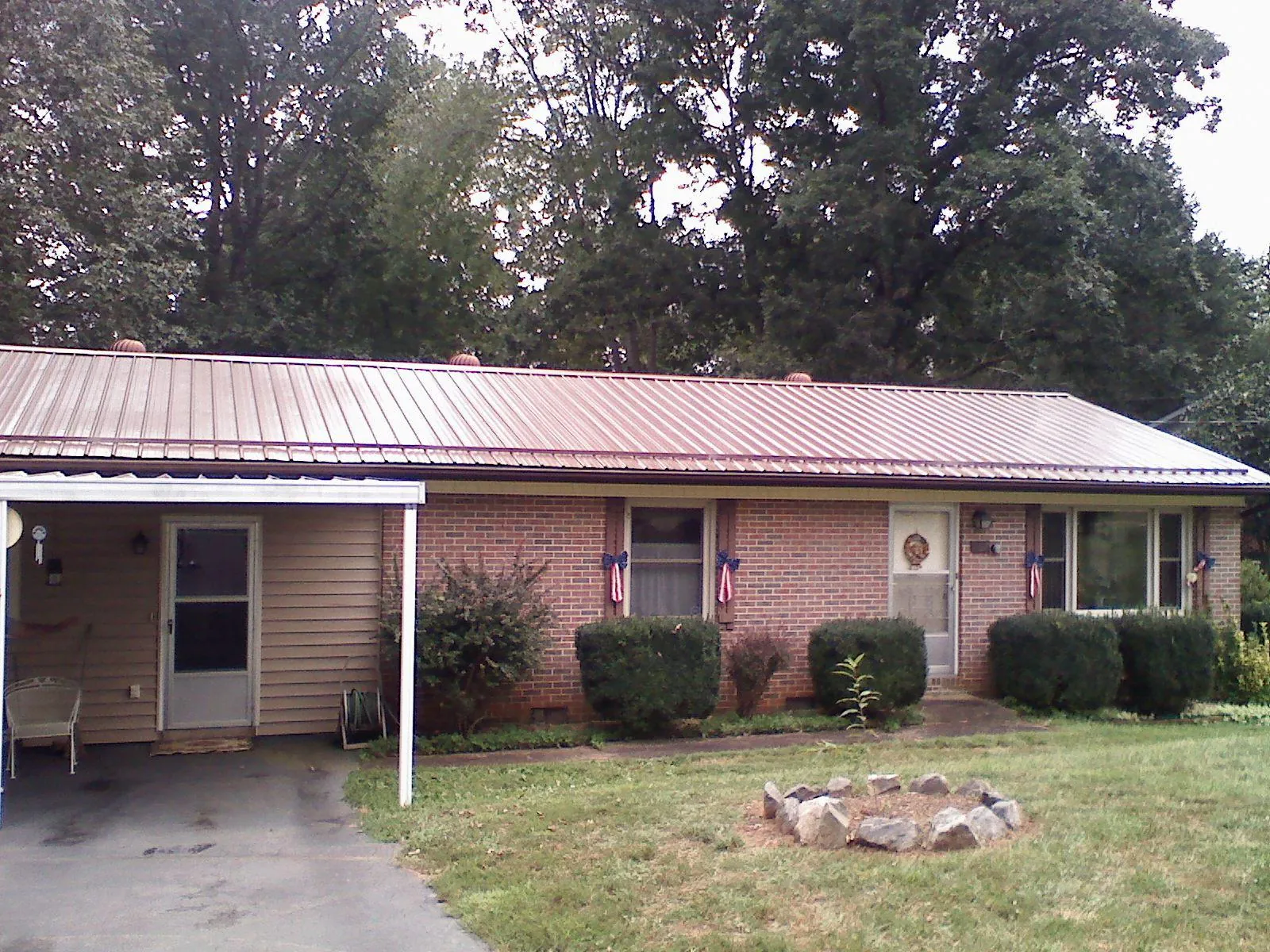 Bronze metal roof and carport on a brick ranch home — Roof Repair work by our crew in Grassflat