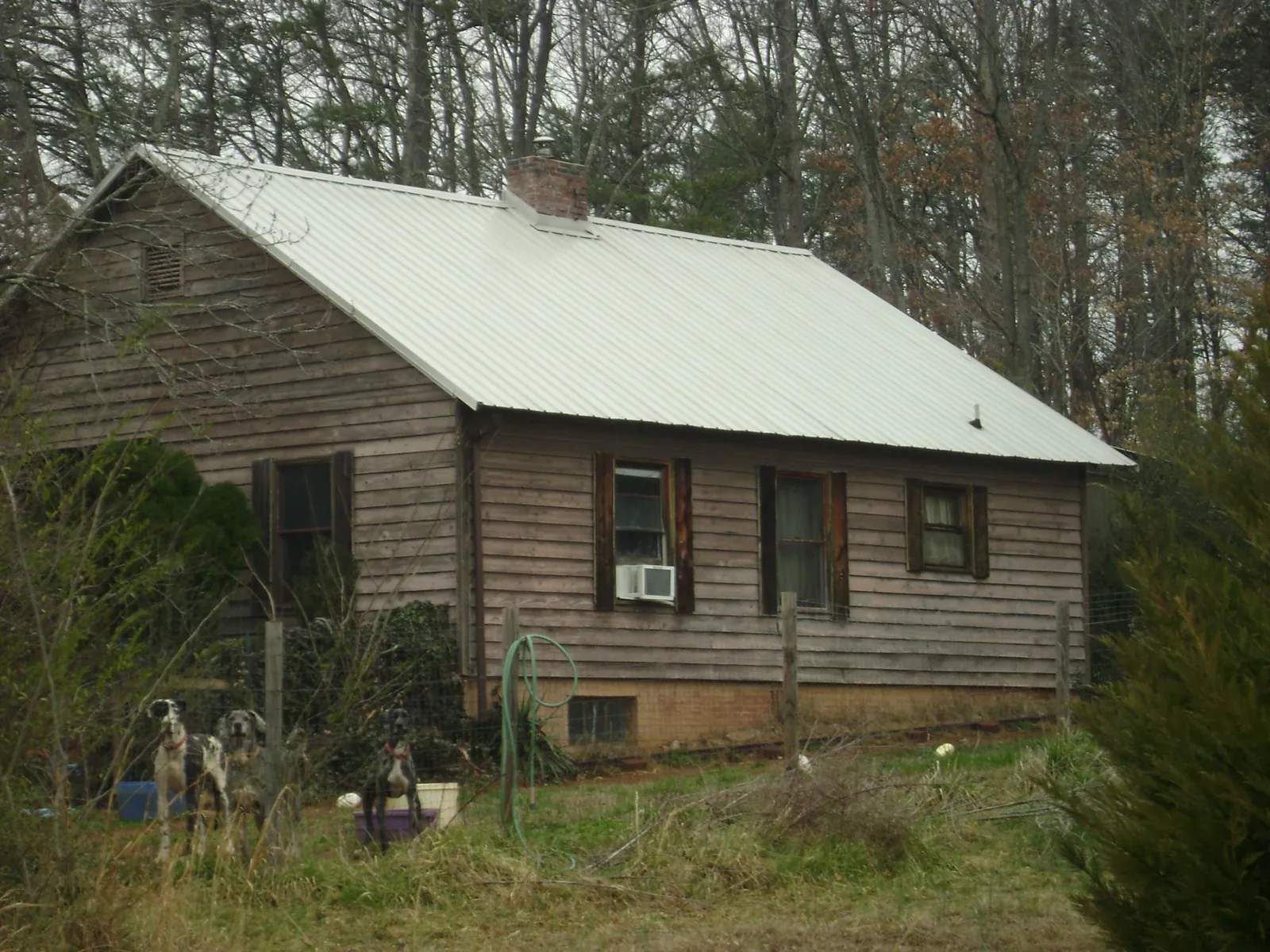 White metal roof on an old wood sided farmhouse, from a Metal Roof Installation job in Grassflat